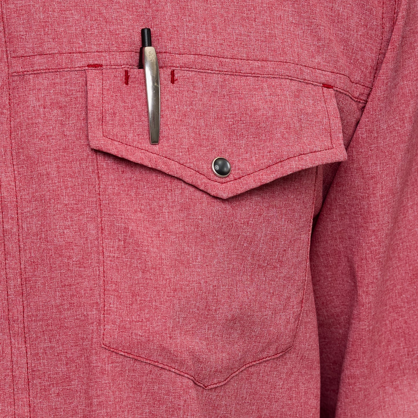 Close-up of a red shirt pocket with a pen inside