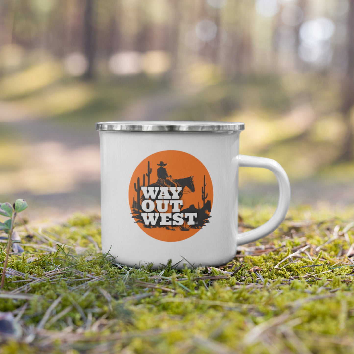 White mug with 'Way Out West' design in a forest setting