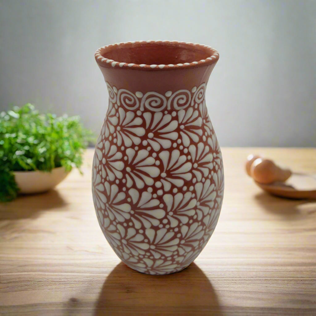 Ceramic vase with floral pattern on a wooden surface