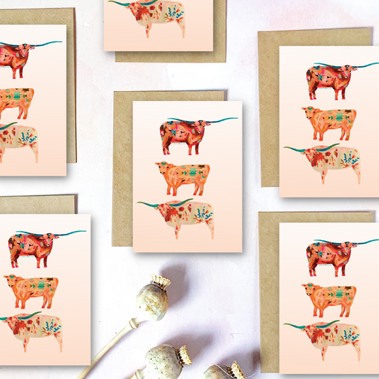 Set of greeting cards with decorative longhorn cattle illustrations on a light background.