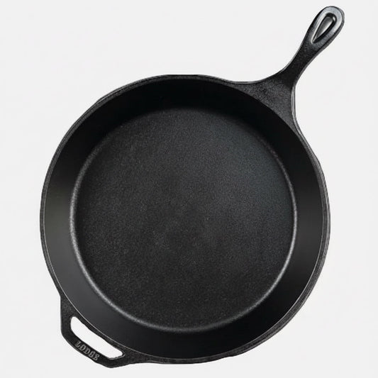 Black cast iron skillet on a black background