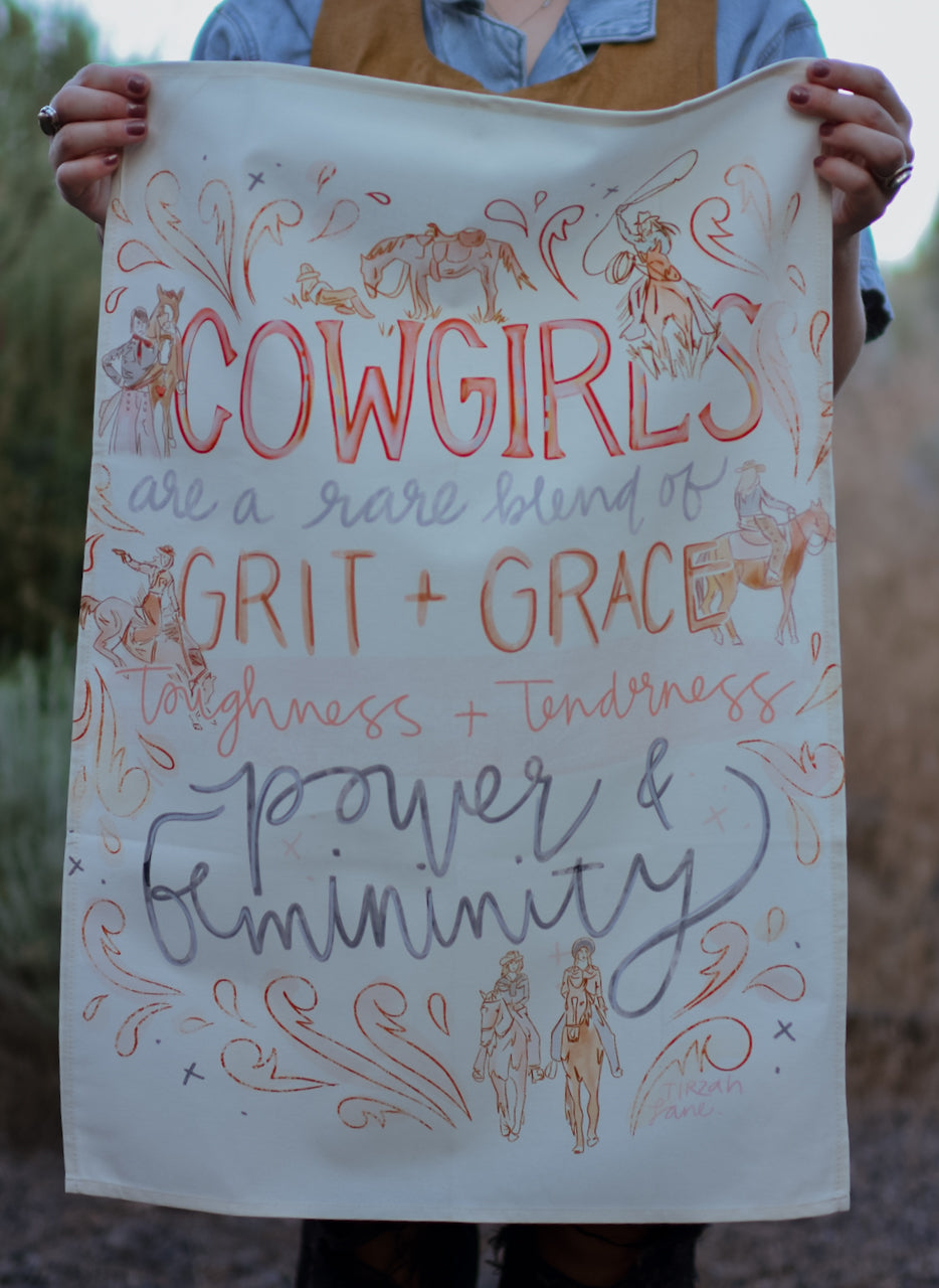 Person holding a towel with 'Cowgirls are a rare blend of grit + grace toughness + tenderness power & femininity' text and illustrations.