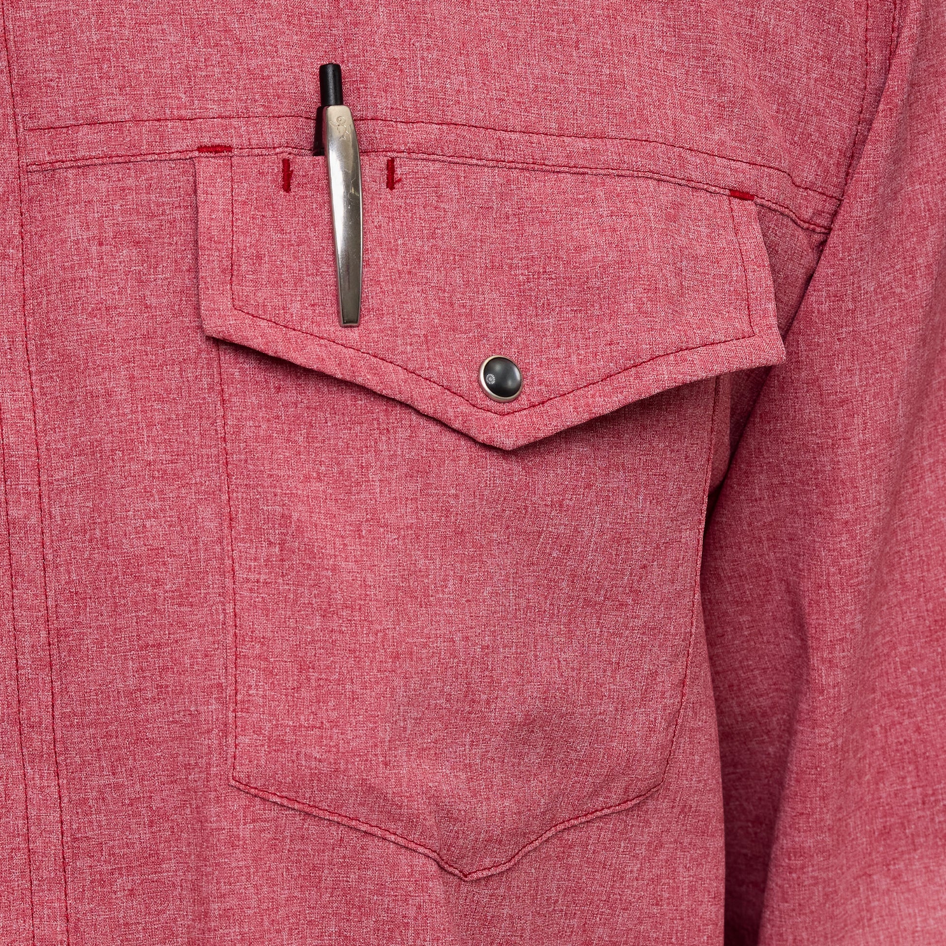 Close-up of a red shirt pocket with a pen inside