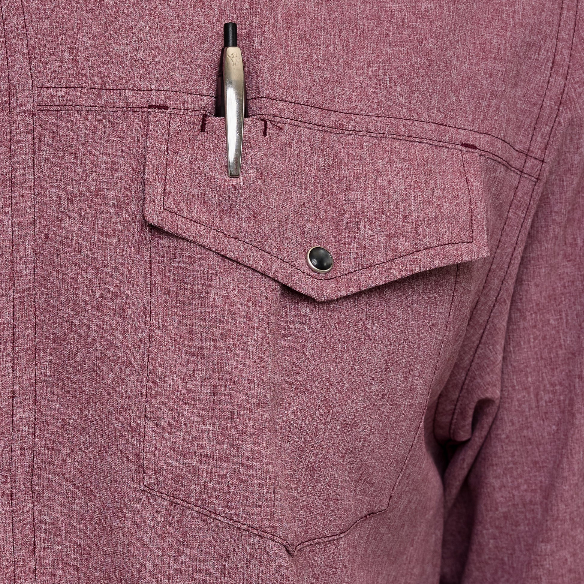 Close-up of a maroon shirt with a pen in the pocket