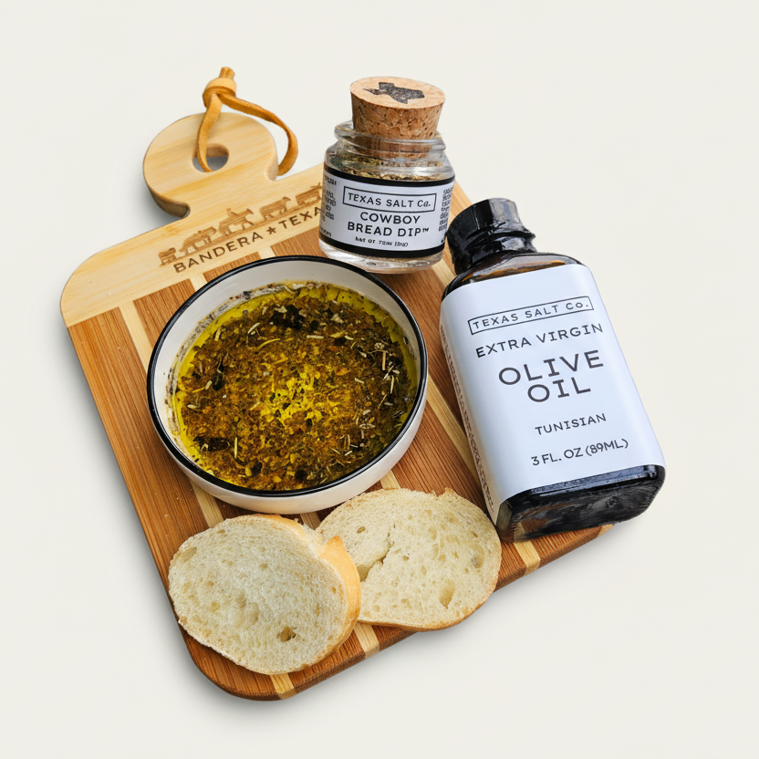 Bread, olive oil, and a jar of seasoning on a wooden board with 'Bandera Texas' branding.