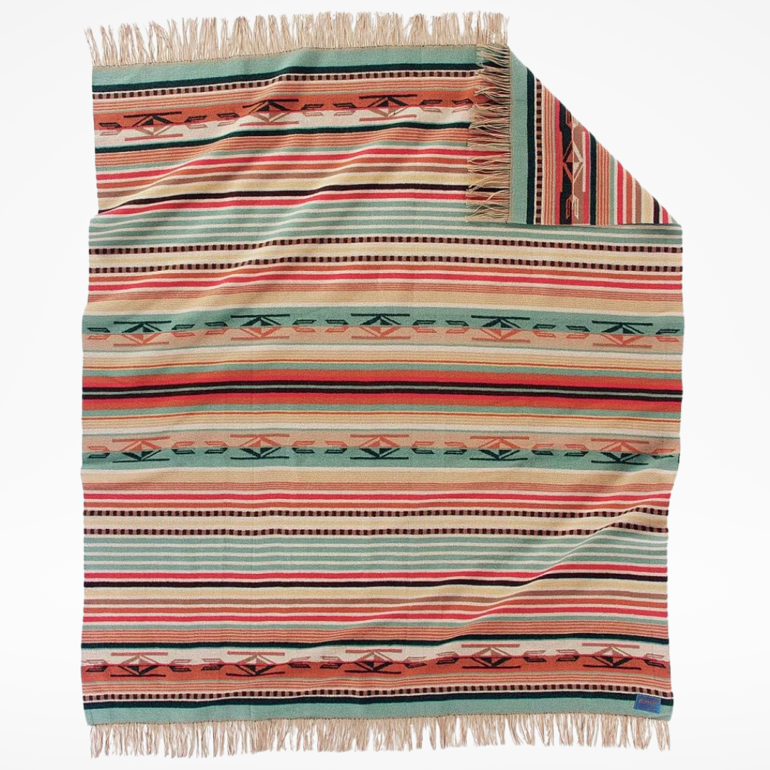 Multicolored striped blanket with fringe on a white background