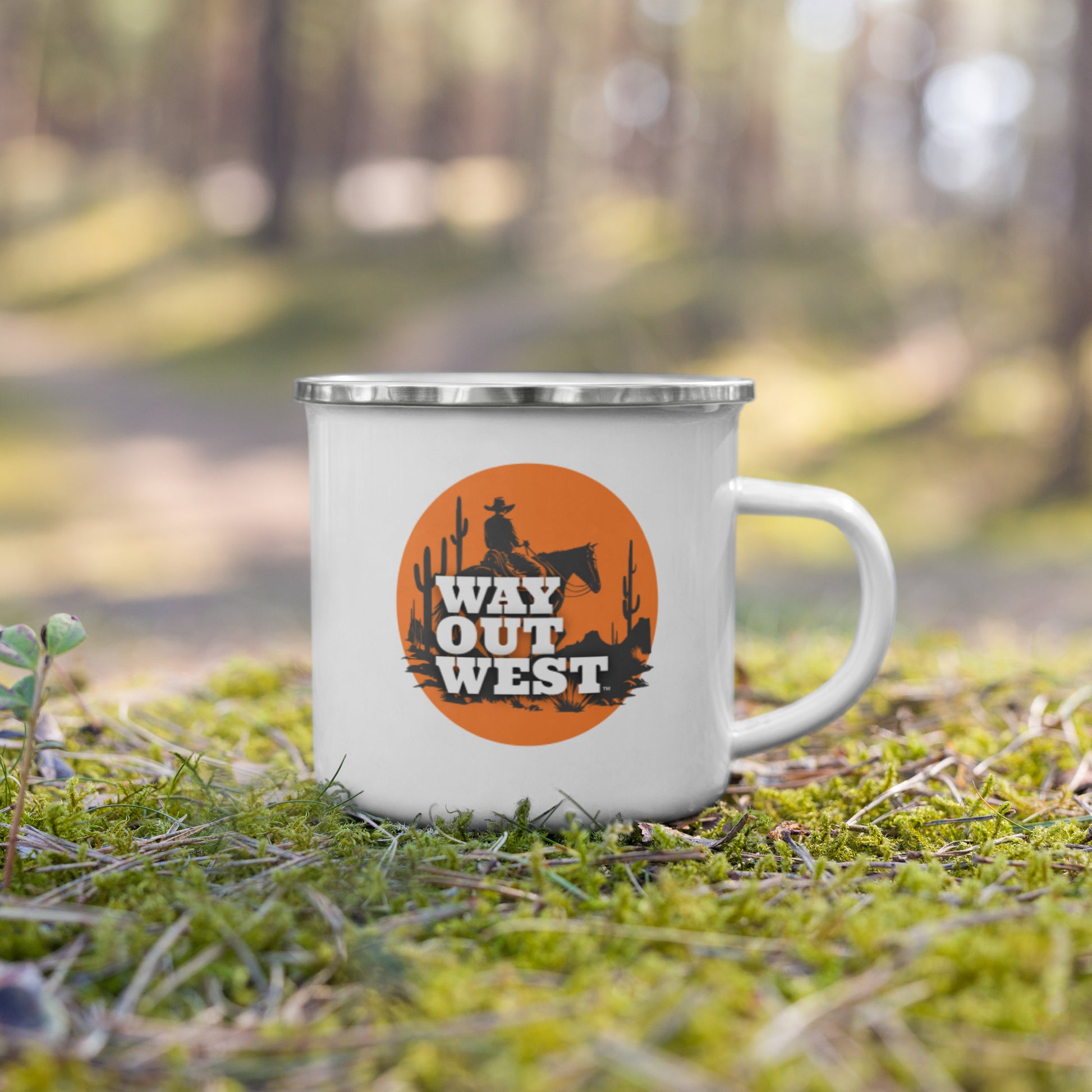 White mug with 'Way Out West' design in a forest setting
