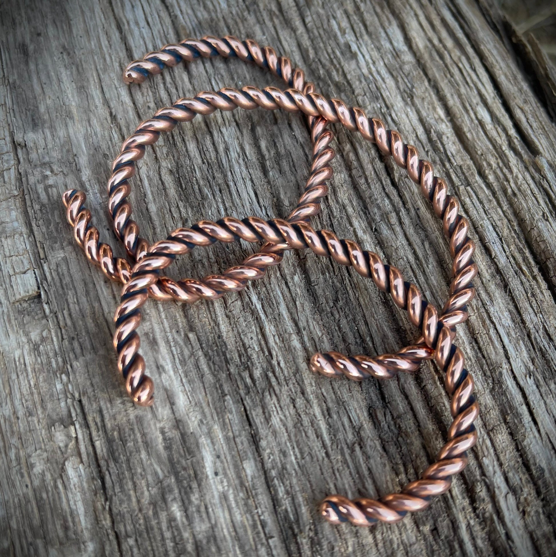 Twisted copper wire on a wooden surface
