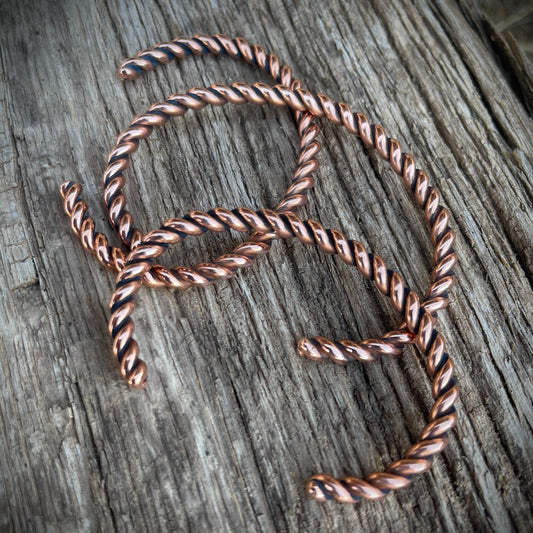 Twisted copper wire on a wooden surface
